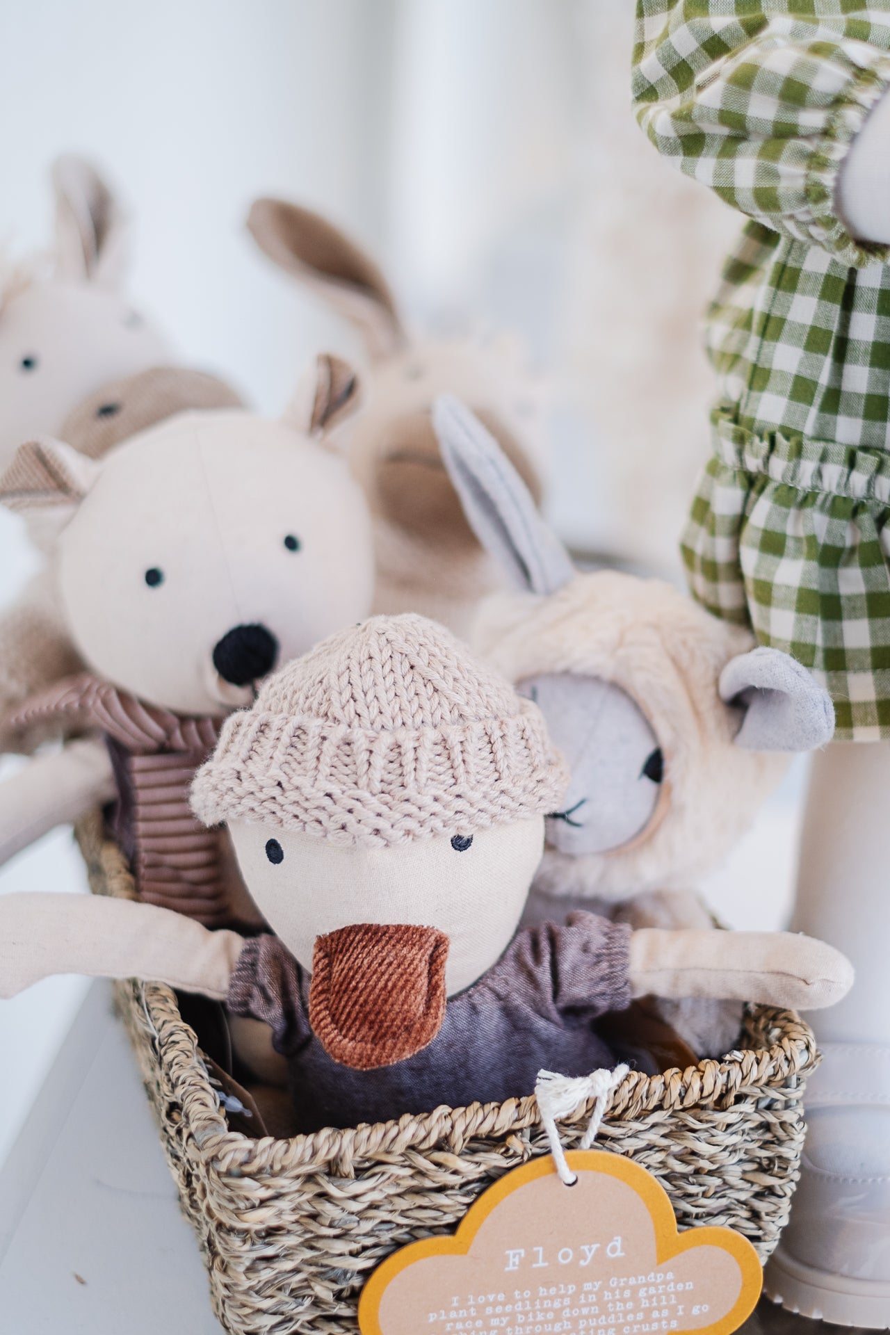 folded stack of sweaters. One grey, white, and orange cable.